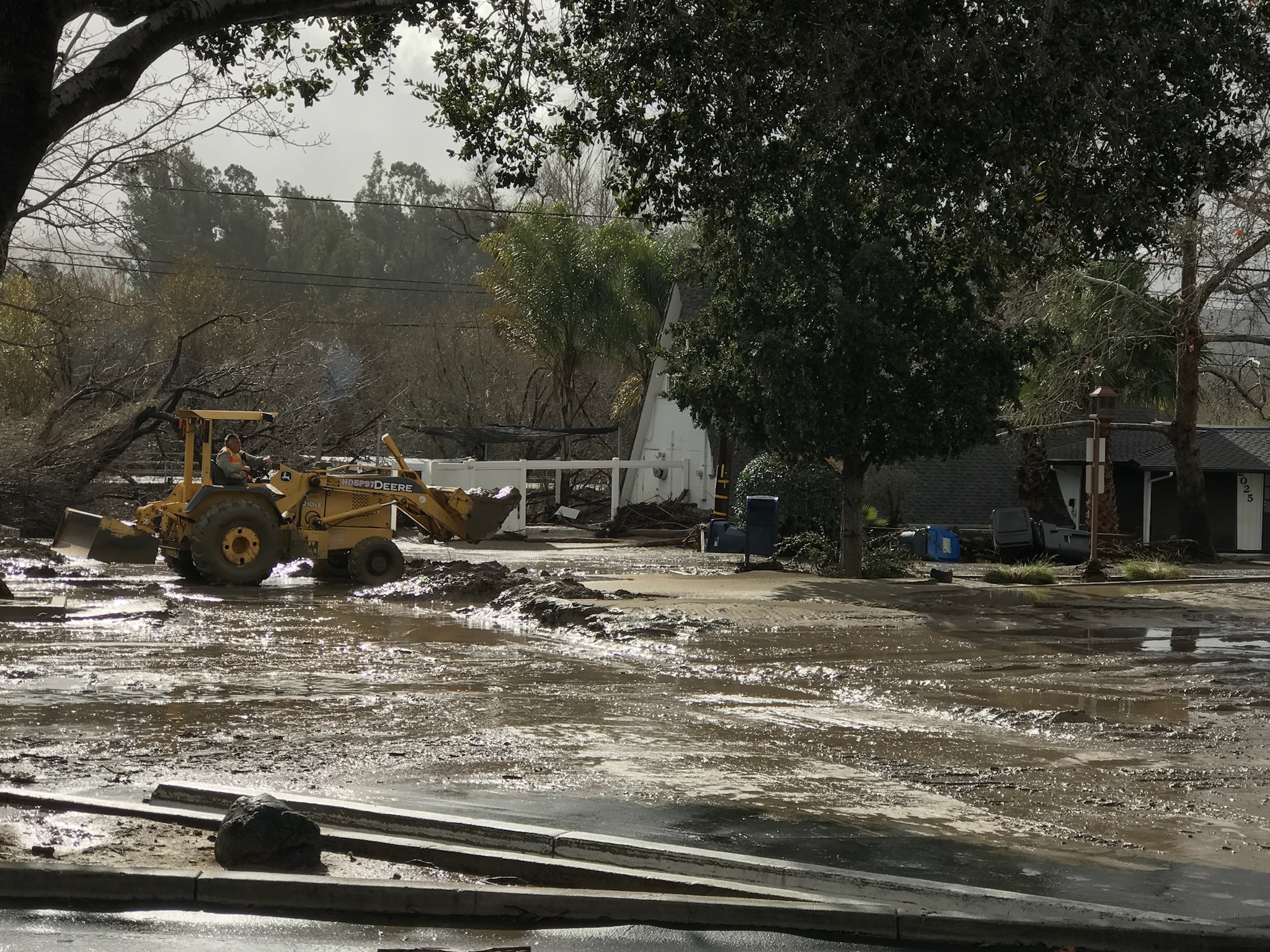 A bulldozer parked on a flooded street