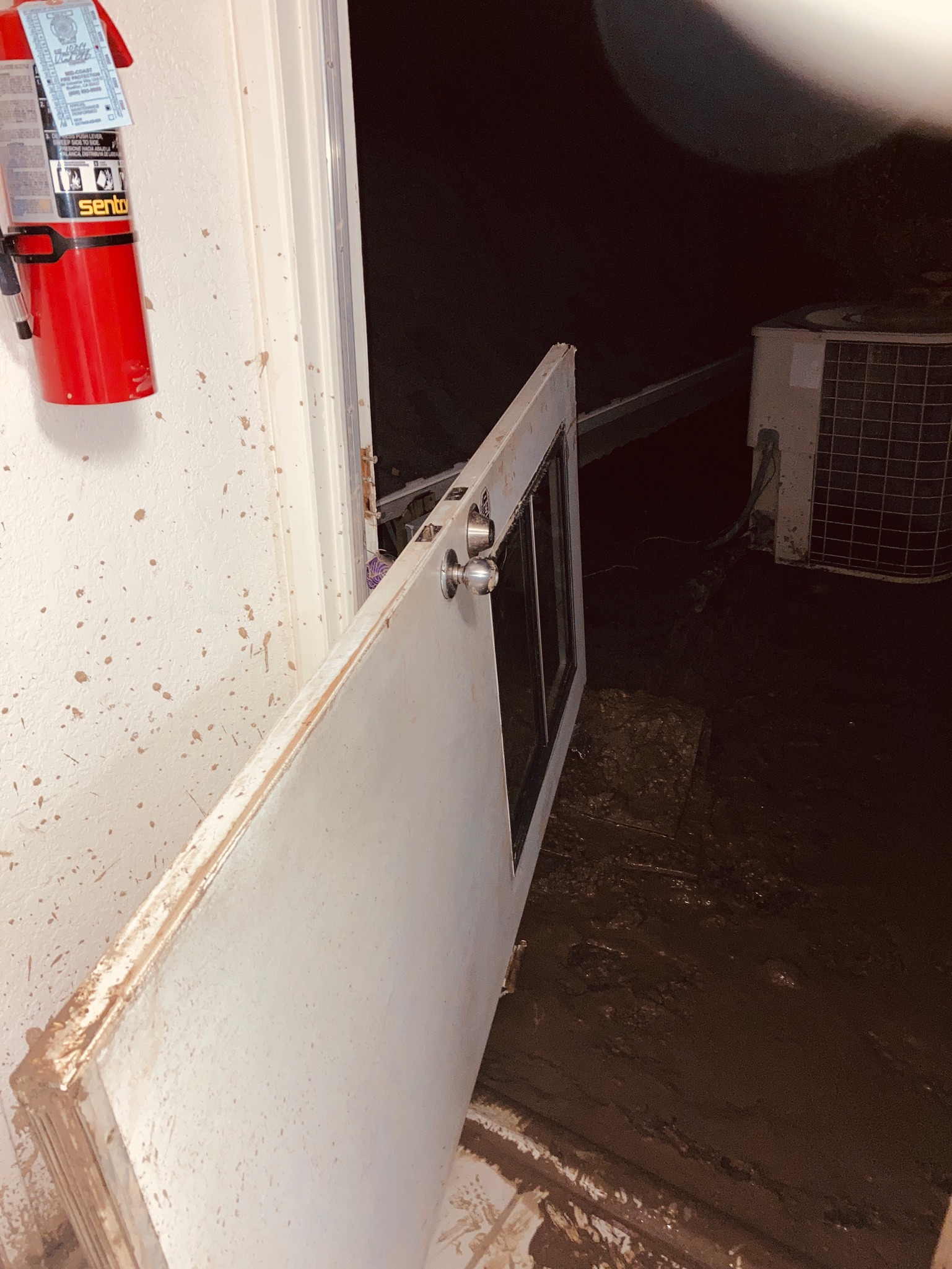 An open door beside a fire hydrant