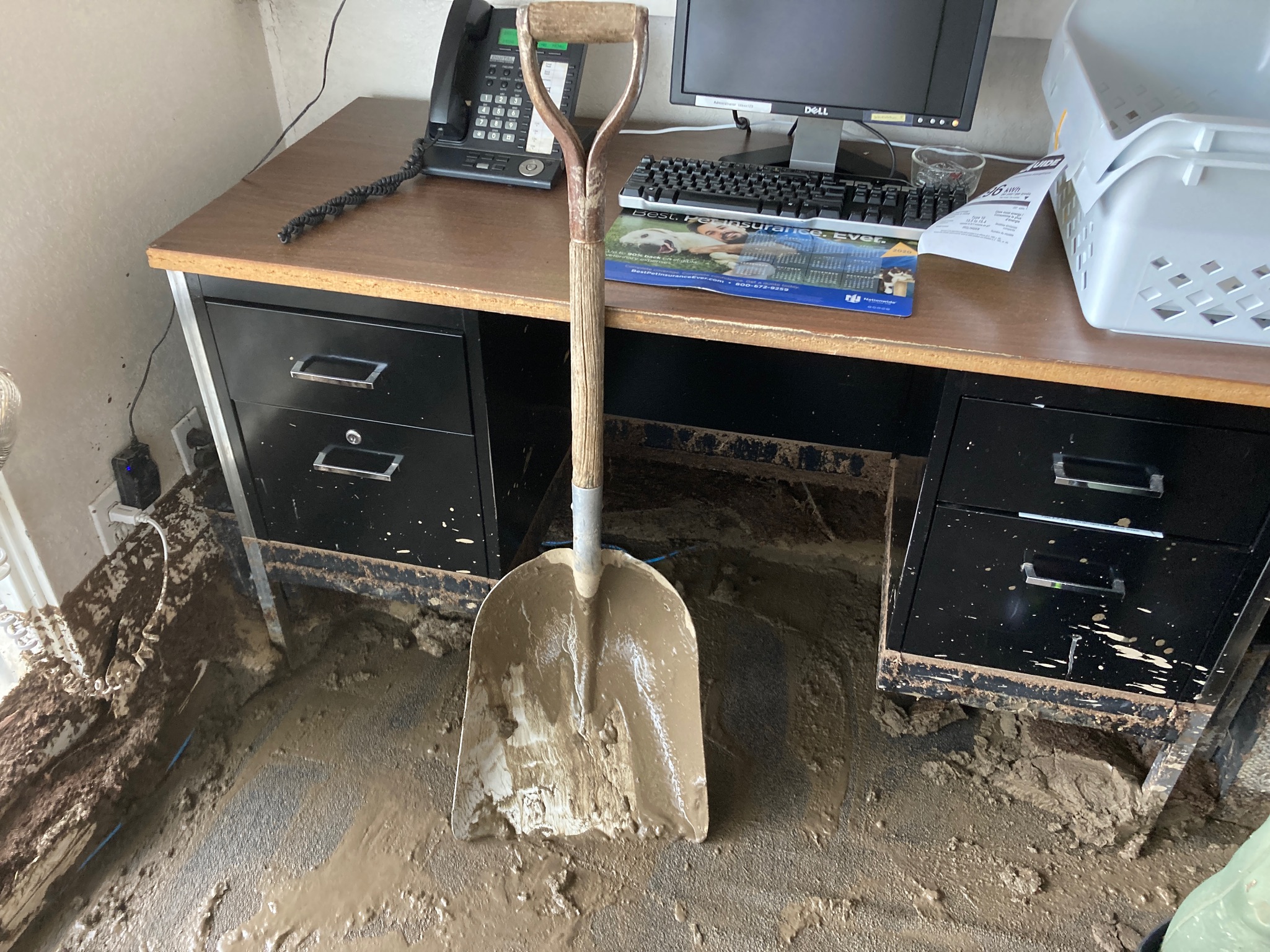 A shovel rests in the mud