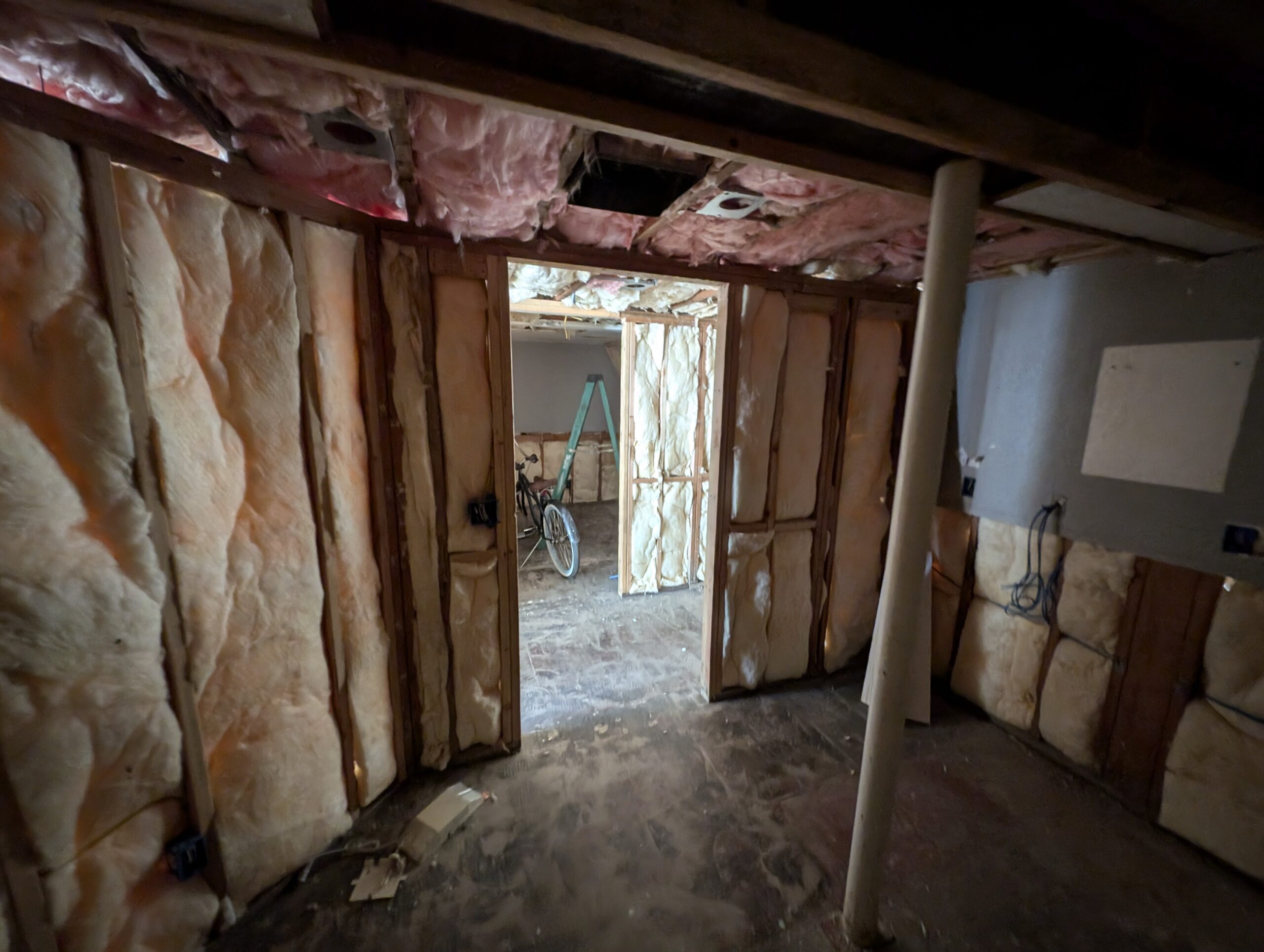 A room featuring insulation and a door leading to the outside