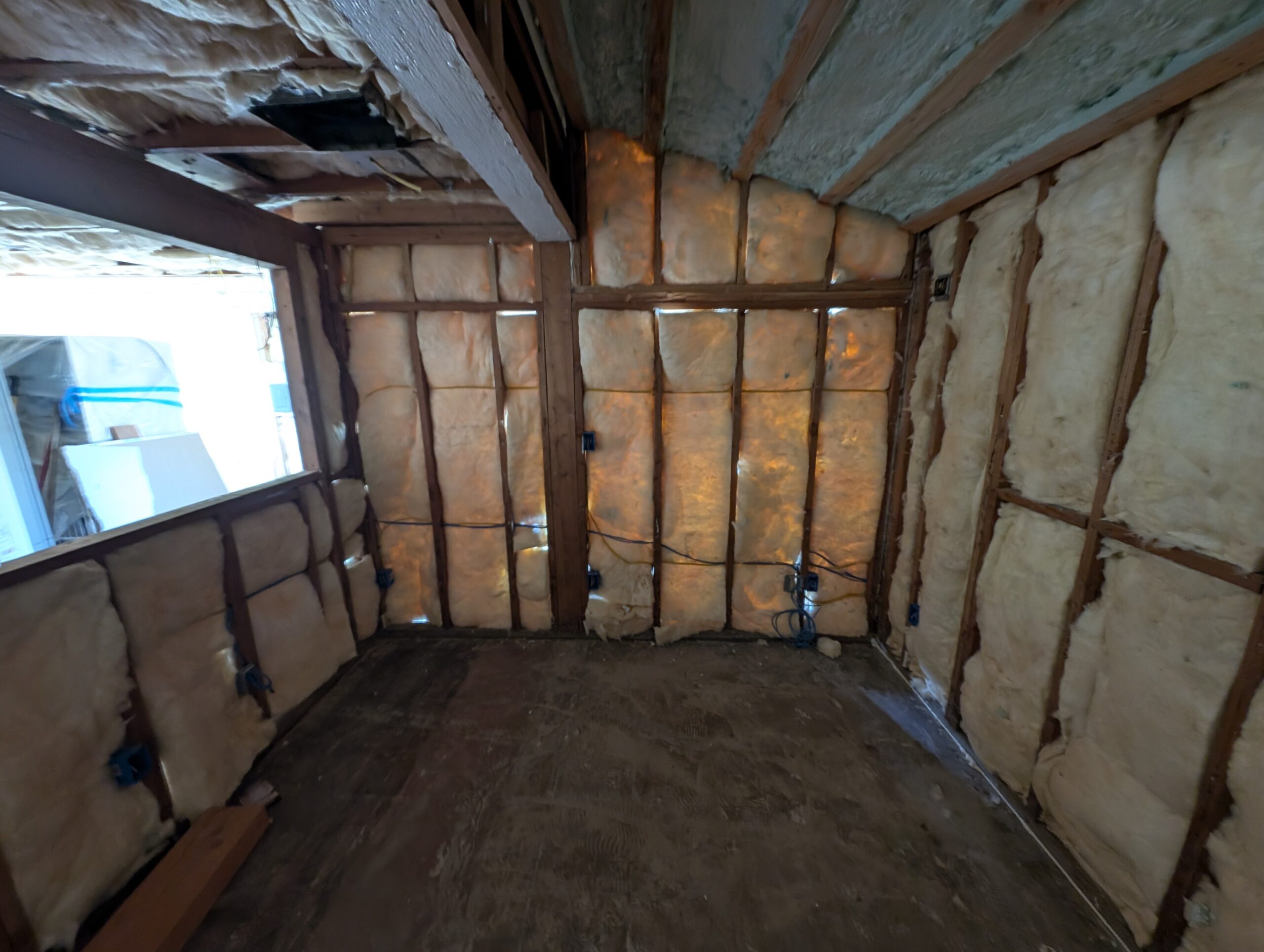 A cozy room featuring insulated wood walls