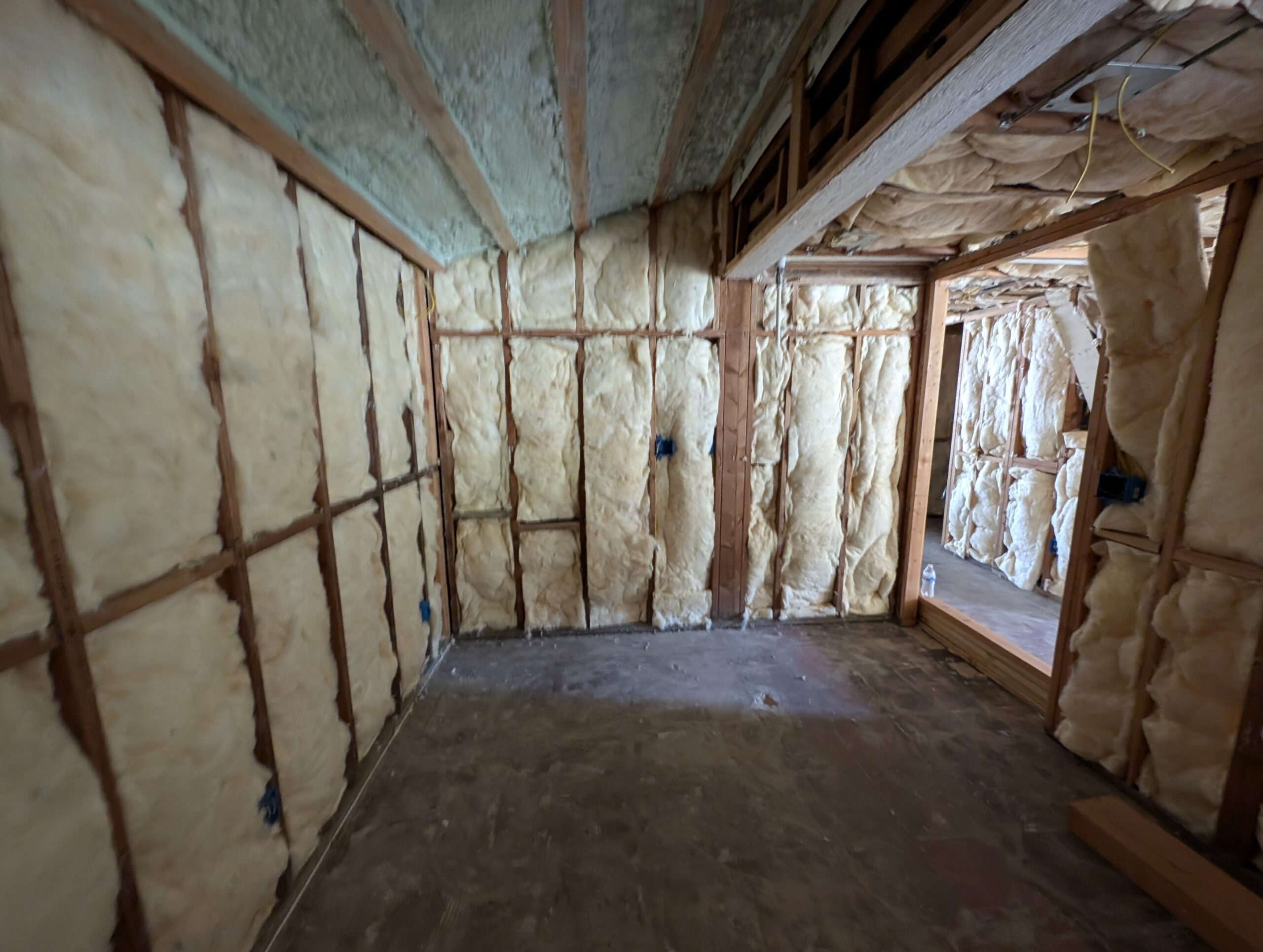 A cozy room featuring insulated wood walls