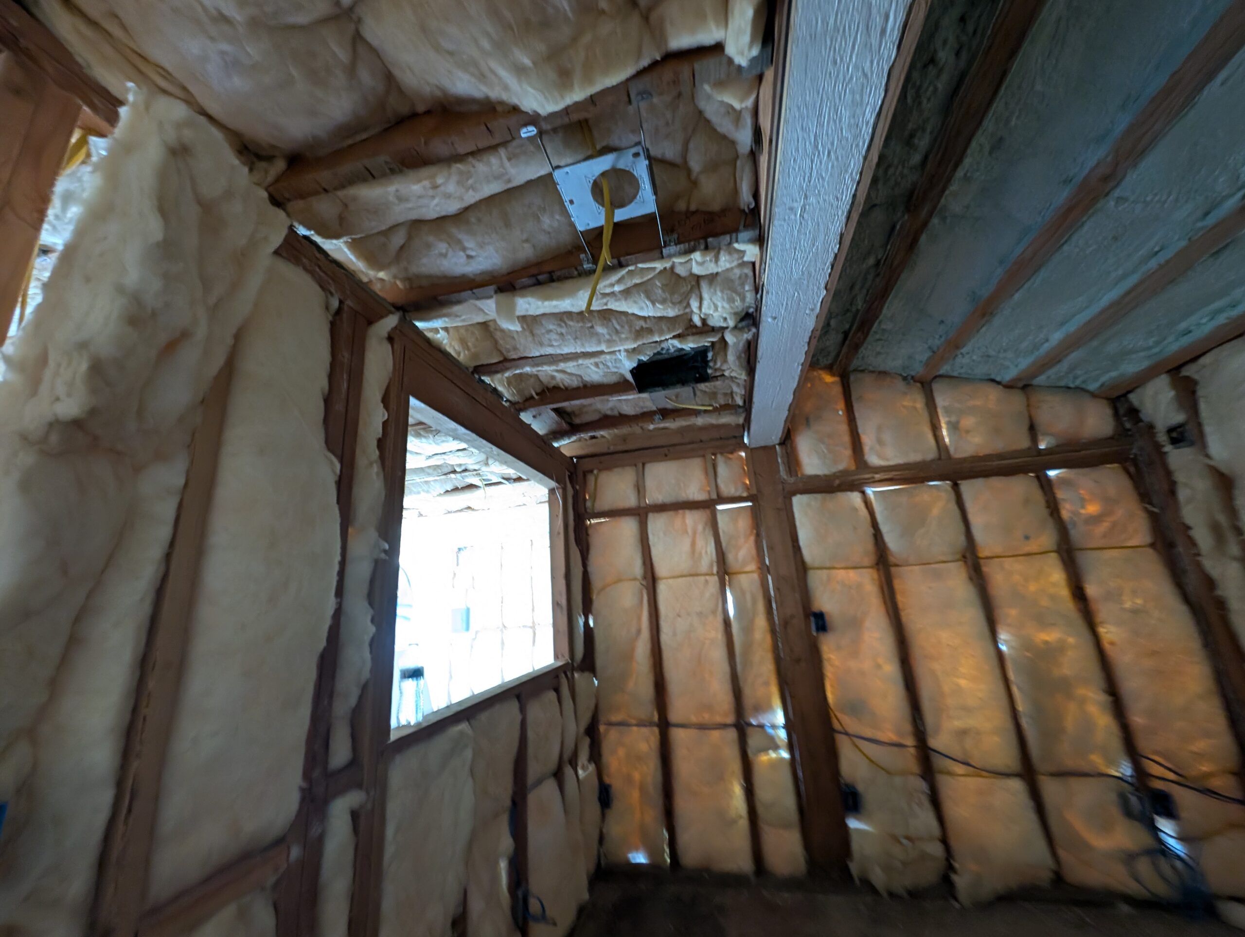 A room showcasing exposed insulation and electrical wires