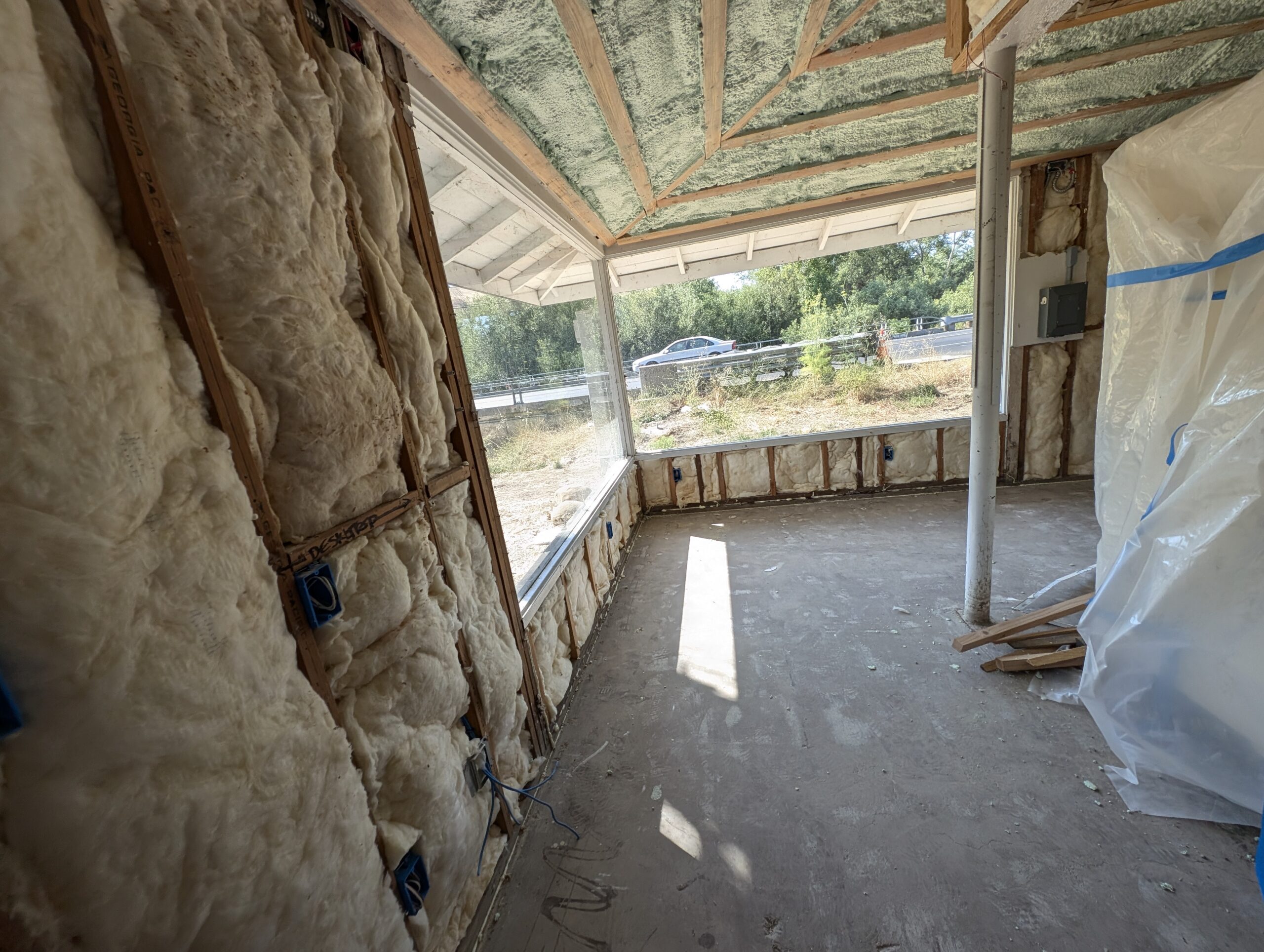 A room featuring insulation on the walls and a window