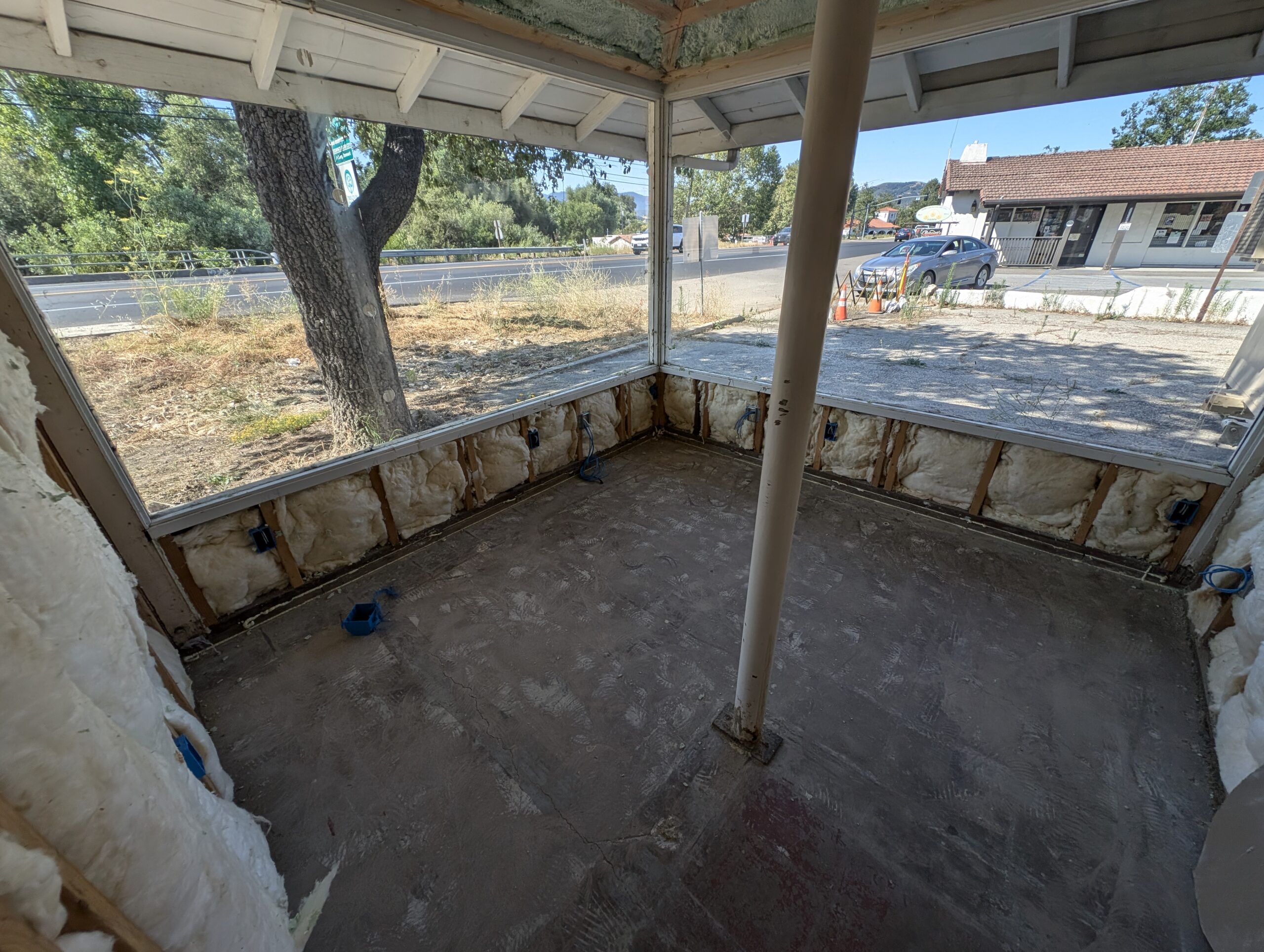 A room under renovation featuring a window and a door