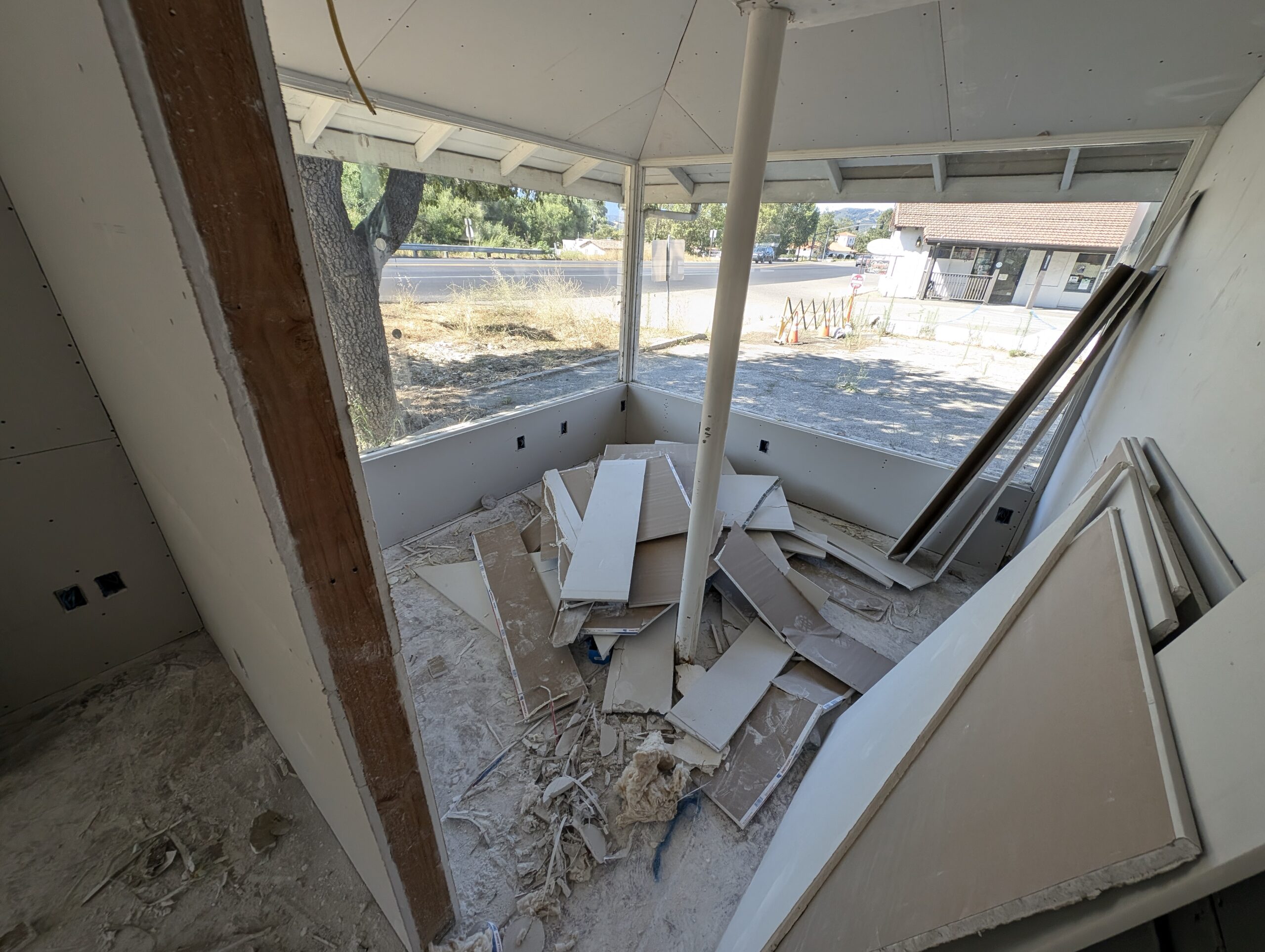 A cluttered room featuring a window