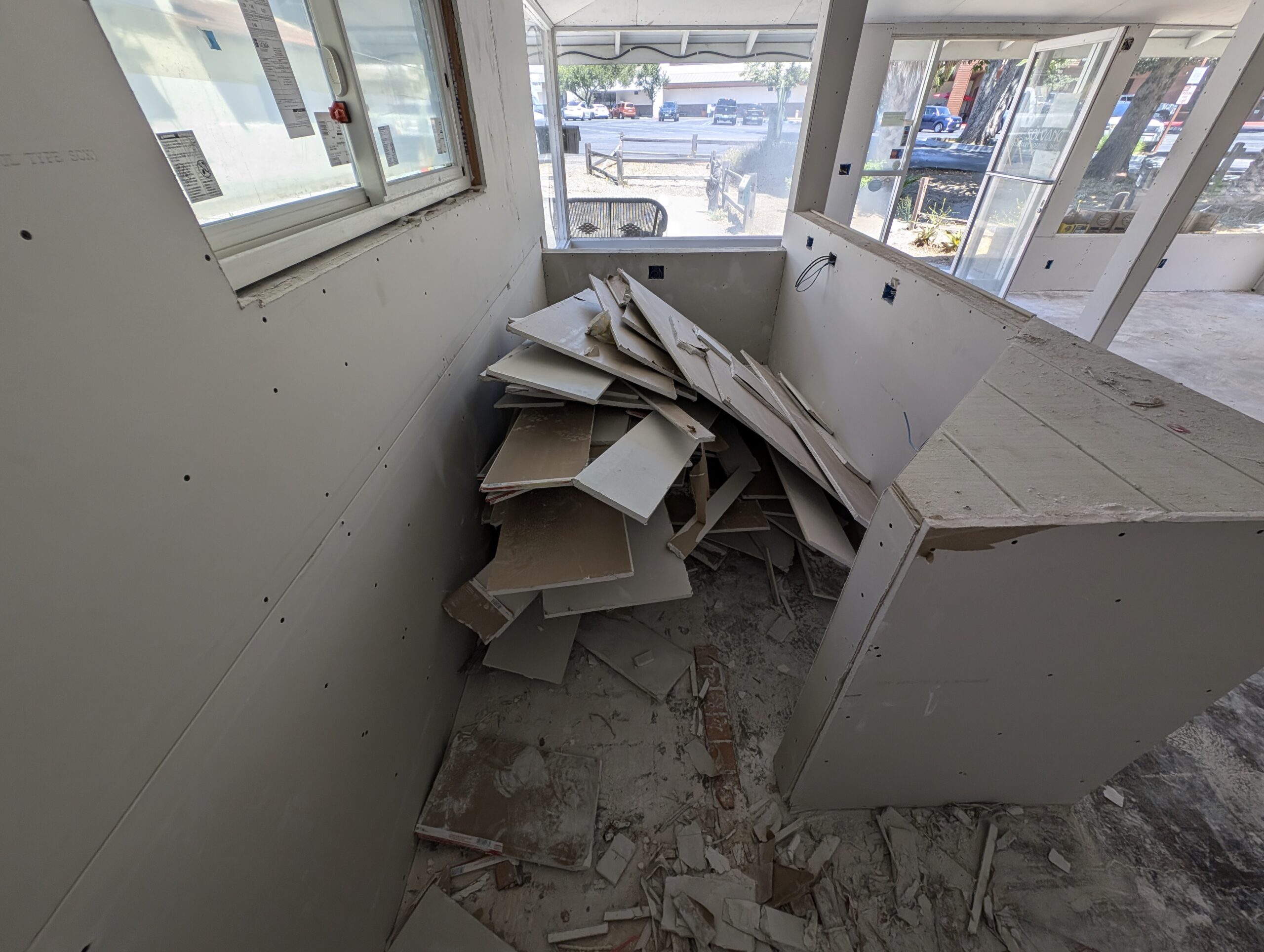 A cluttered filled with debris and broken cabinets