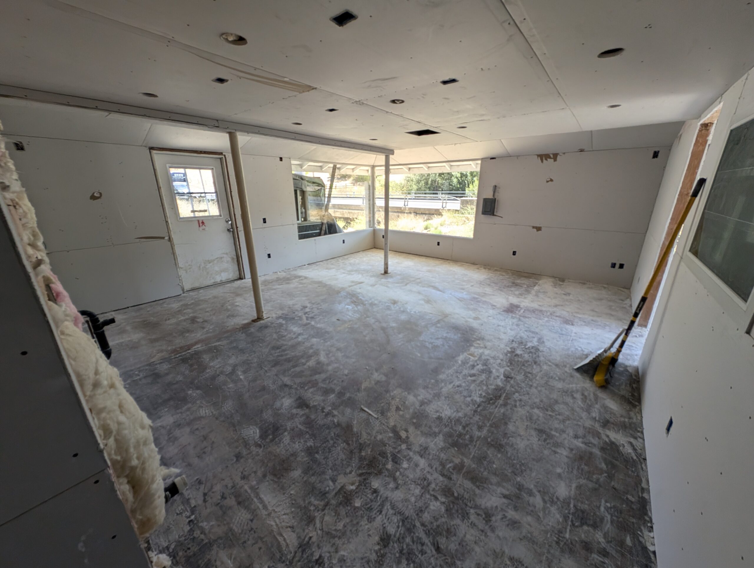 A cluttered room filled with various construction equipment