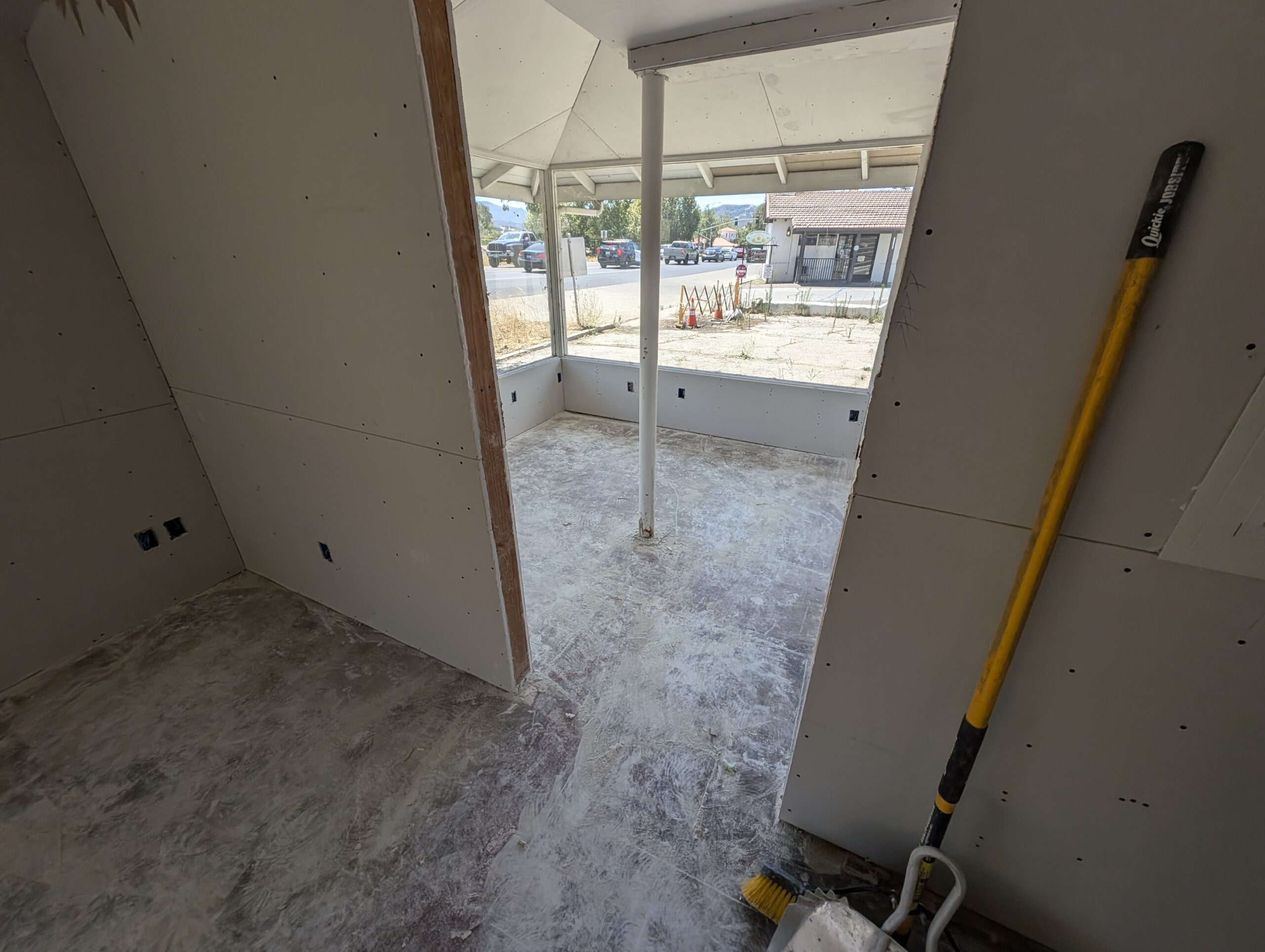 A room featuring a yellow shovel placed on the floor