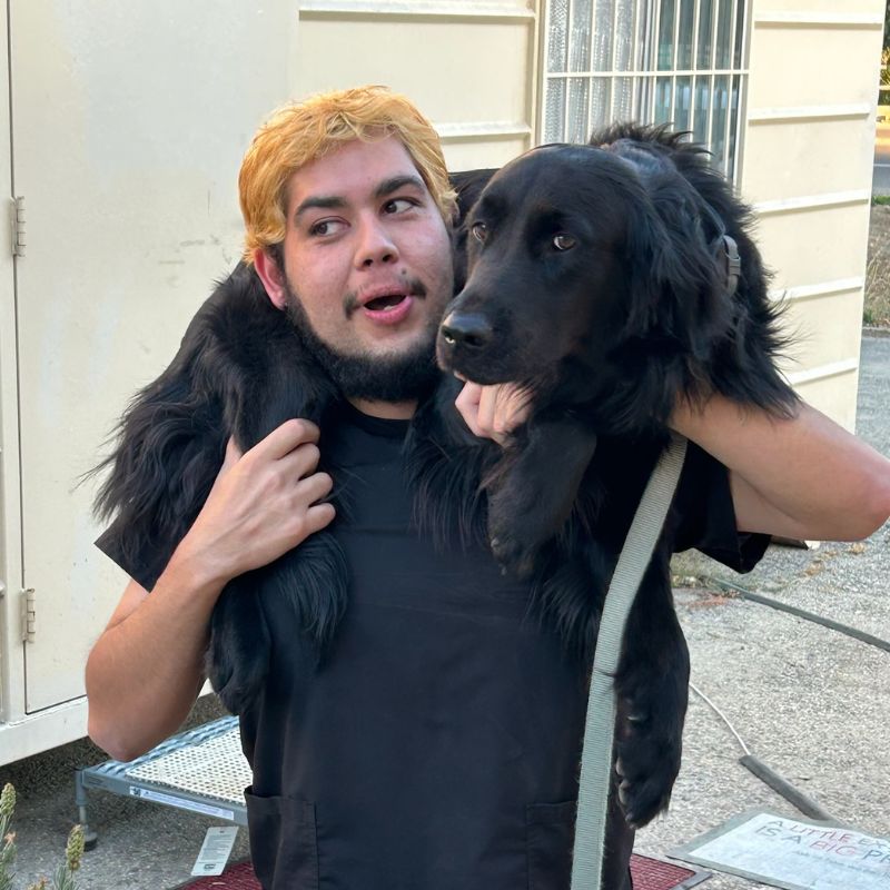 about-imgn A man carries a dog on his shoulders